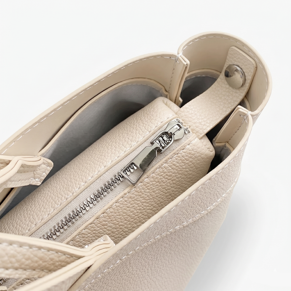 Beige handbag with a zipper on a light gray background